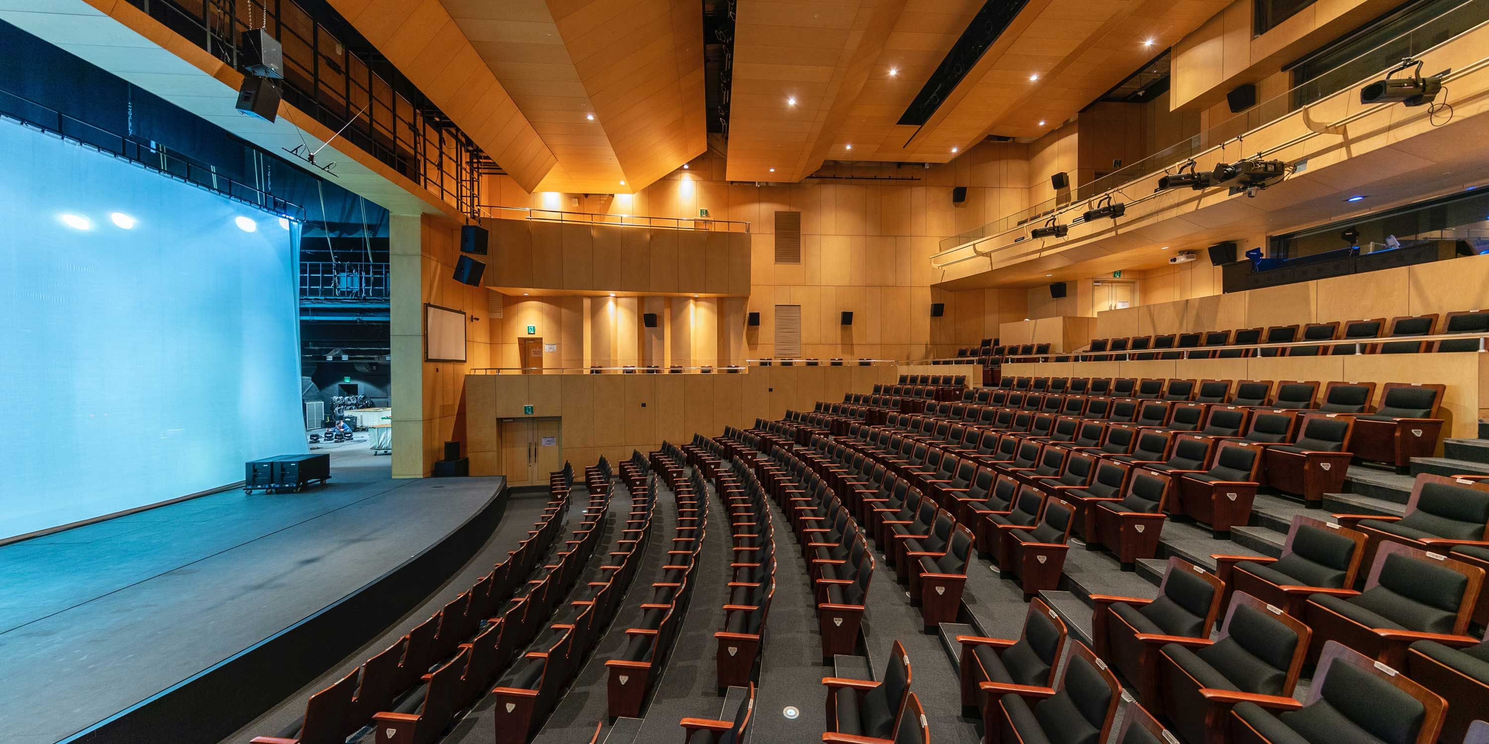 classroom or auditorium with padded chairs and wooden accents
